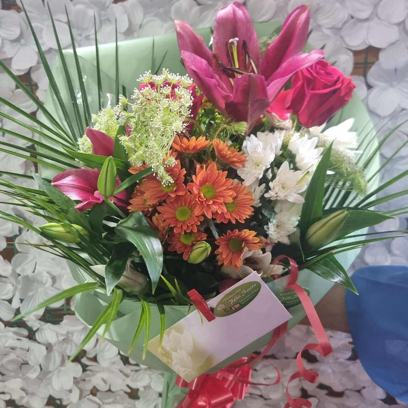 Colorful bouquet of mixed flowers with carnations, daisies, and greenery, perfect for gifts.